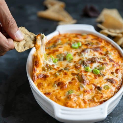 Baked Buffalo Chicken Dip Cheese Pull with a tortilla chip.