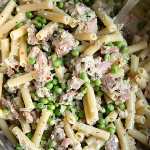 A dish is filled with ham and pea pasta