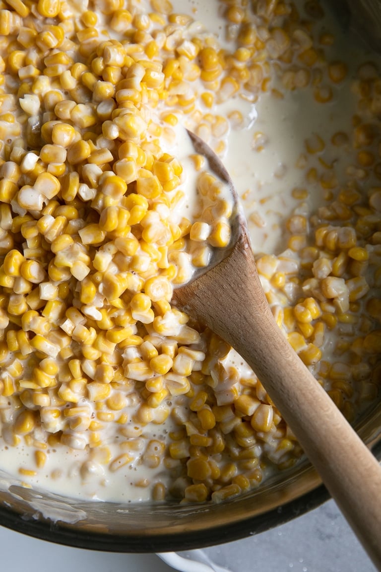Crock Pot filled with corn kernels in a homemade cream sauce.
