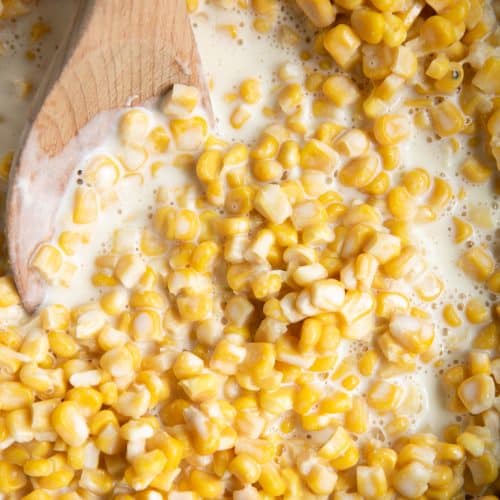 Creamed corn in a large shallow pot.