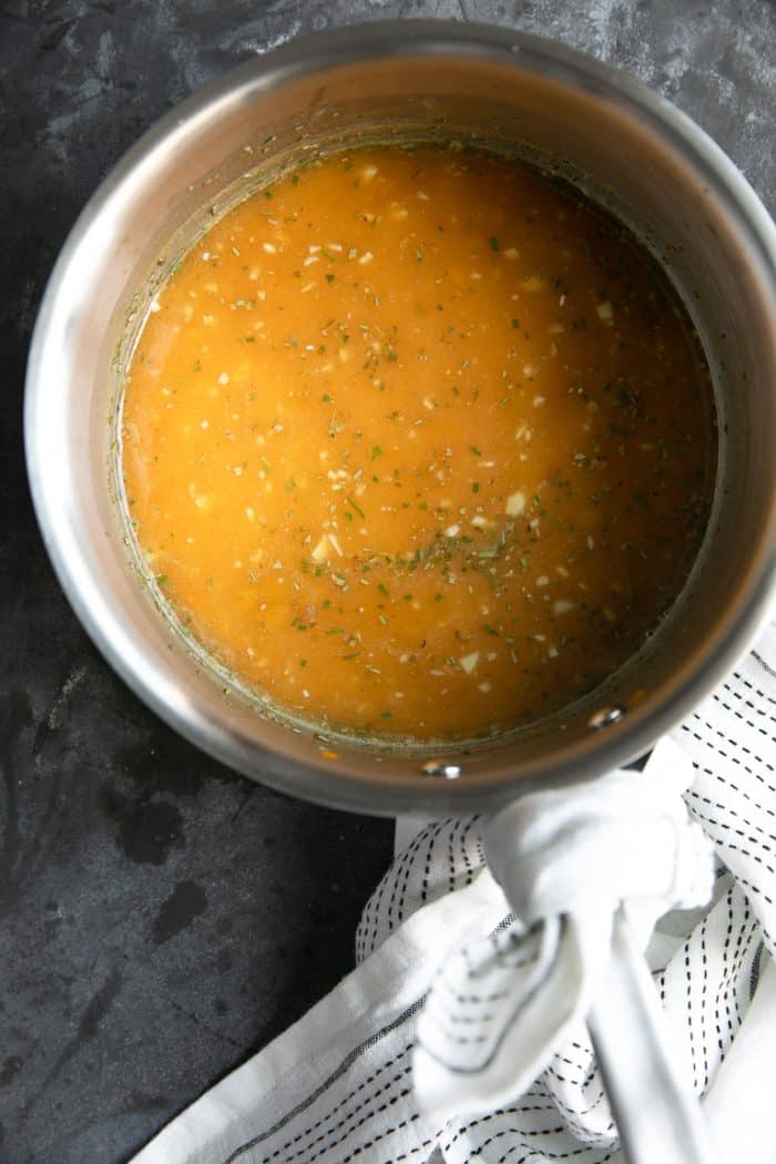 ham glaze being cooked in a pot for marmalade glazed ham