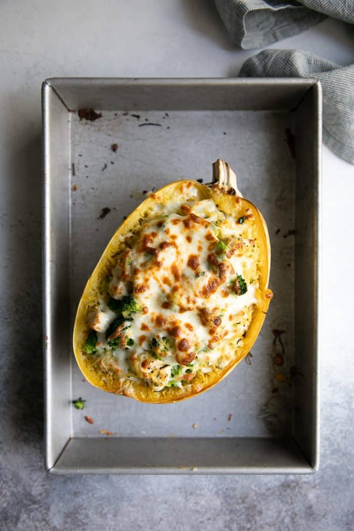 Stuffed Spaghetti Squash half filled with chicken, broccoli, and three different types of cheeses.