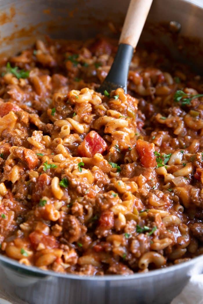 Large pot filled with cheesy, beefy, noodle-filled American goulash ready to be served.