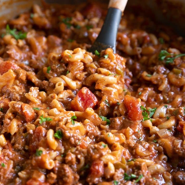 Large pot filled with cheesy, beefy, noodle-filled American goulash ready to be served.