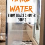 shower door half covered in translucent hard water, half cleaned and clear