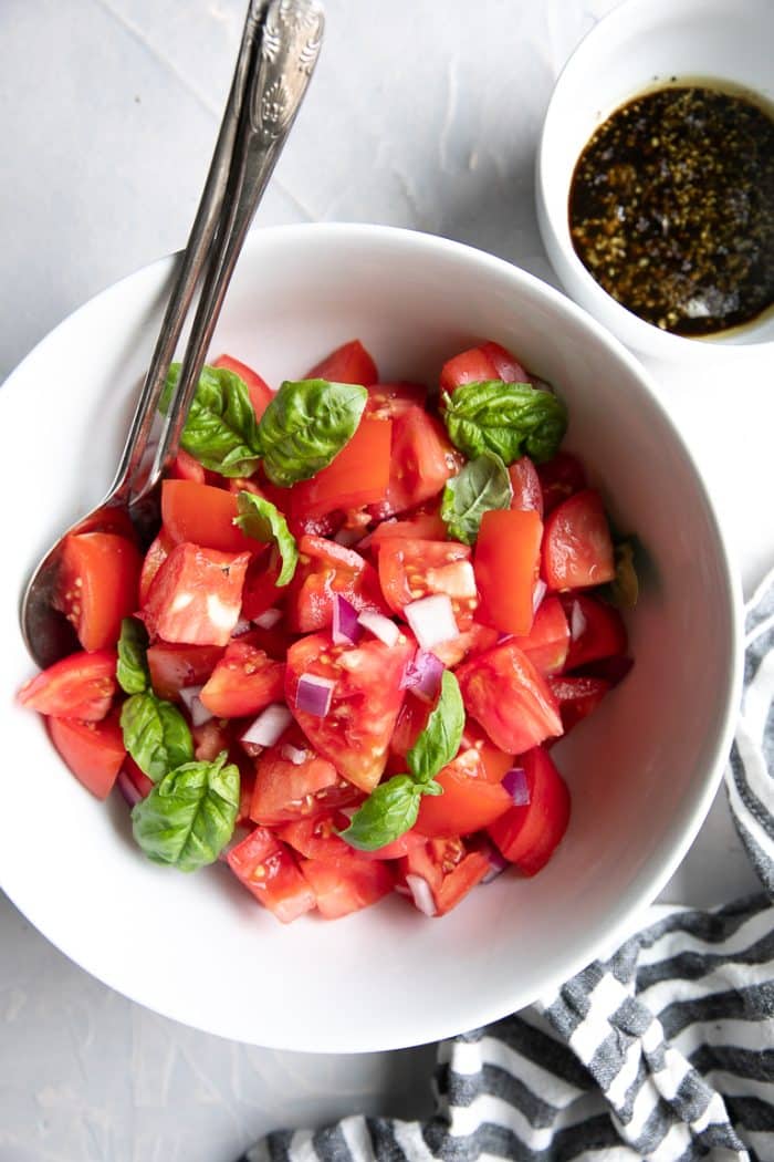 Fresh Tomato Basil Salad with a side of olive oil and balsamic vinegar.