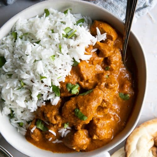 A bowl of chicken tikka masala with rice