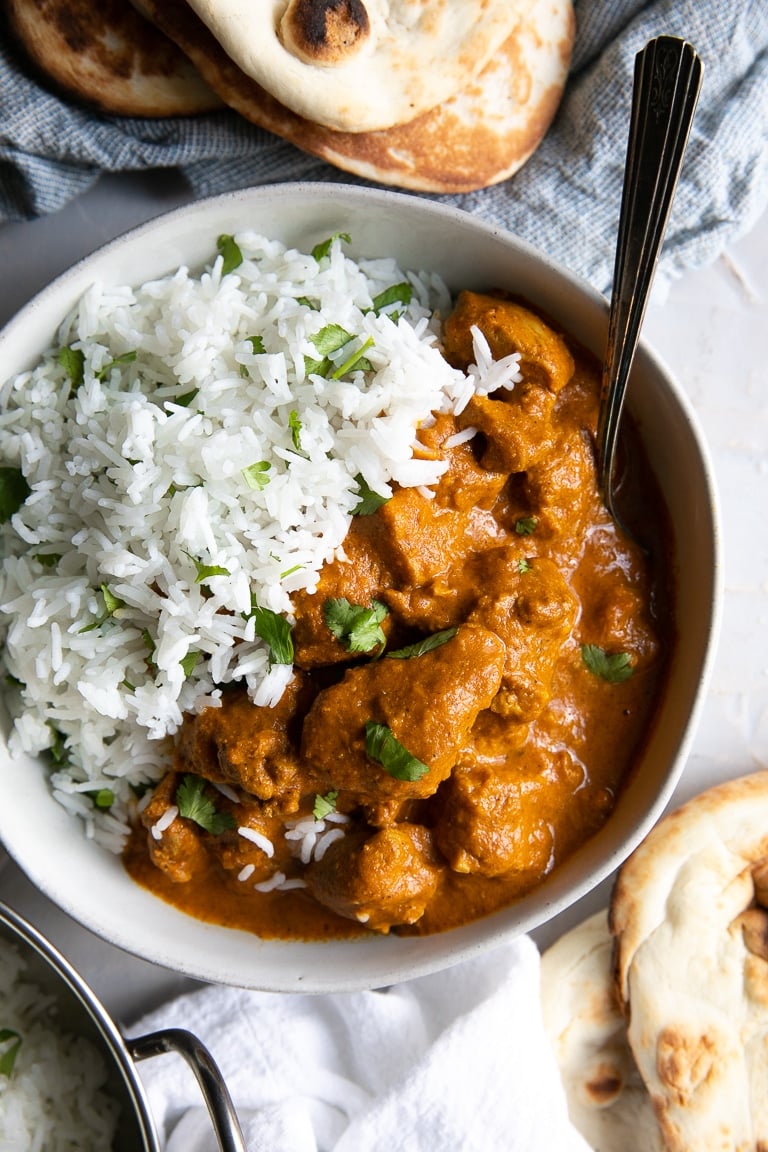 A bowl of chicken tikka masala with rice