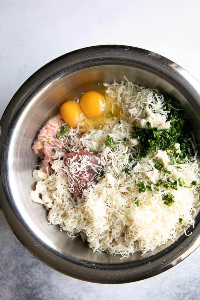 Ingredients for the meatballs in Italian Wedding Soup in a large mixing bowl.