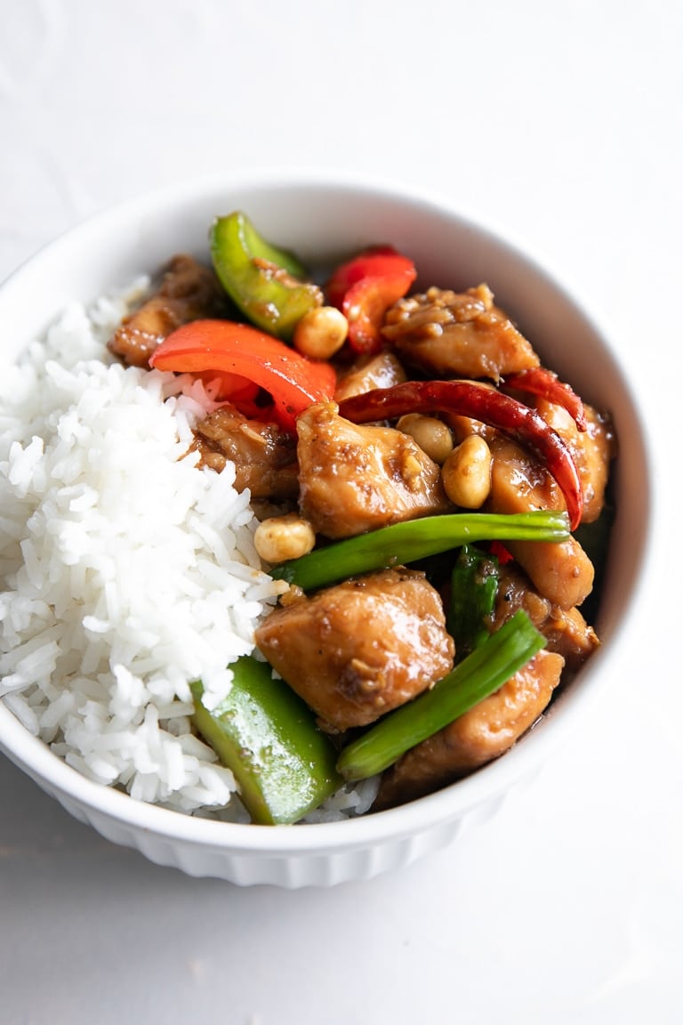 Close-up image of Kung Pao Chicken with a side of white rice.