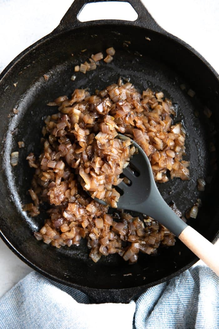 Cast iron skillet with chopped and cooked caramelized onions.