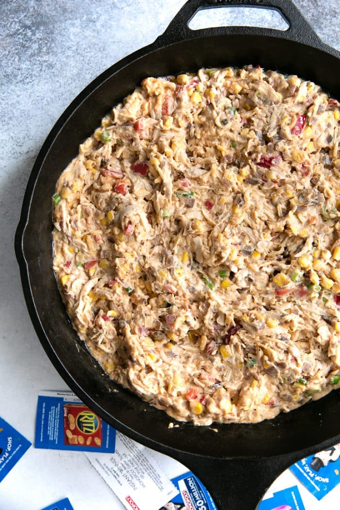 Large cast iron skillet filled with pre-cooked bbq chicken dip.