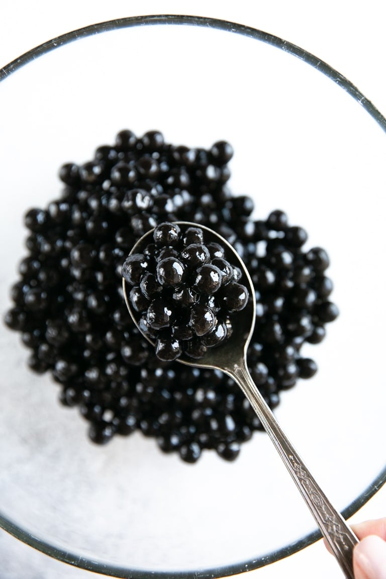 Quick-cooking black boba on a glass bowl (tapioca pearls).