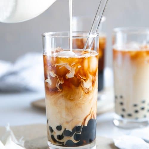 A glass of Bubble Tea being poured