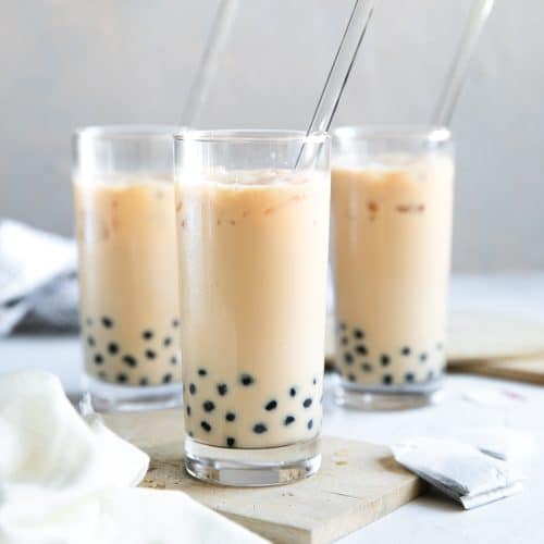 3 glasses of Bubble Tea on a table, with Boba at the bottom of the glasses