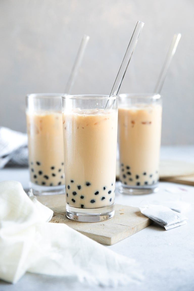 Three glasses filled with bubble tea made with black tea and half-and-half