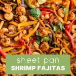 Overhead image of roasted shrimp fajitas on a baking sheet with a green text overlay that reads โSheet Pan Shrimp Fajitasโ