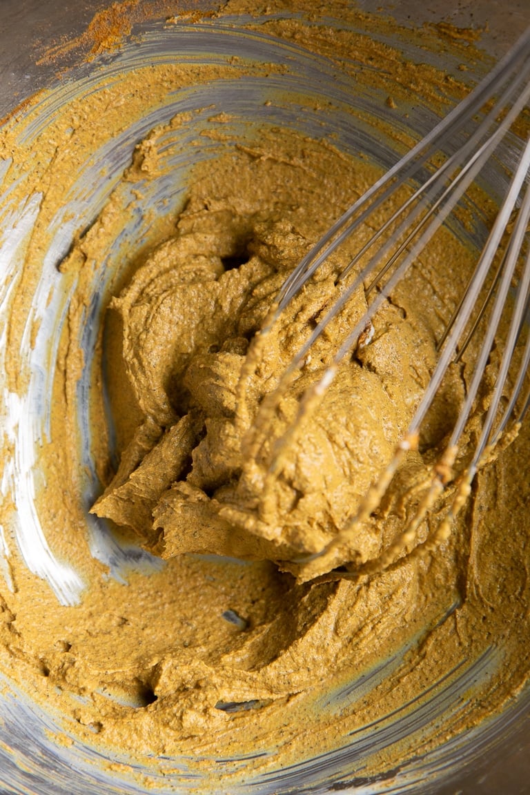 yogurt and marinade ingredient spices fully whisked together in a mixing bowl