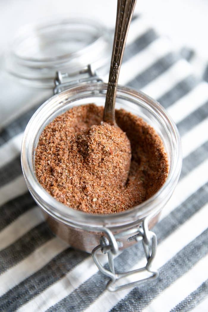 A jar on a table, with taco seasoning