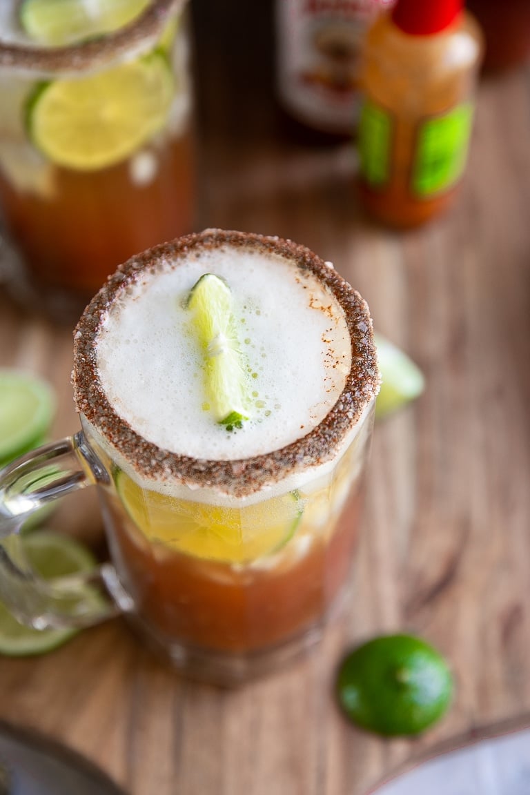 Large stein filled with clamato juice, light Mexican beer, and fresh limes.