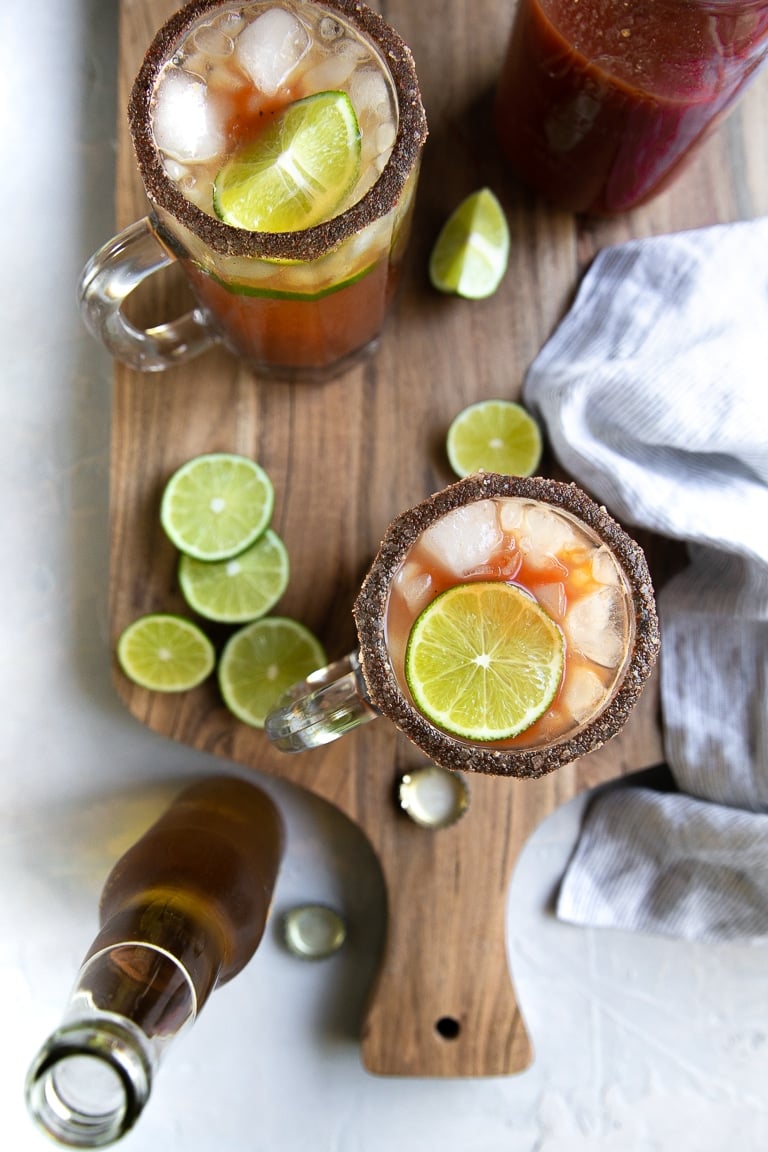 Overhead image of two beer steins filled with prepared Micheladas.