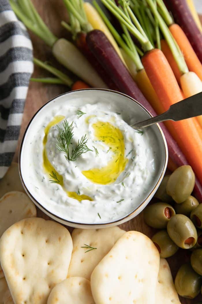 Authentic tzatziki sauce garnished with olive oil and fresh dill.