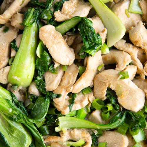 Overhead image of chicken and bok choy stir fried in a light sauce.