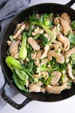 Overhead image of Chicken and bok choy stir fry in a light sauce.