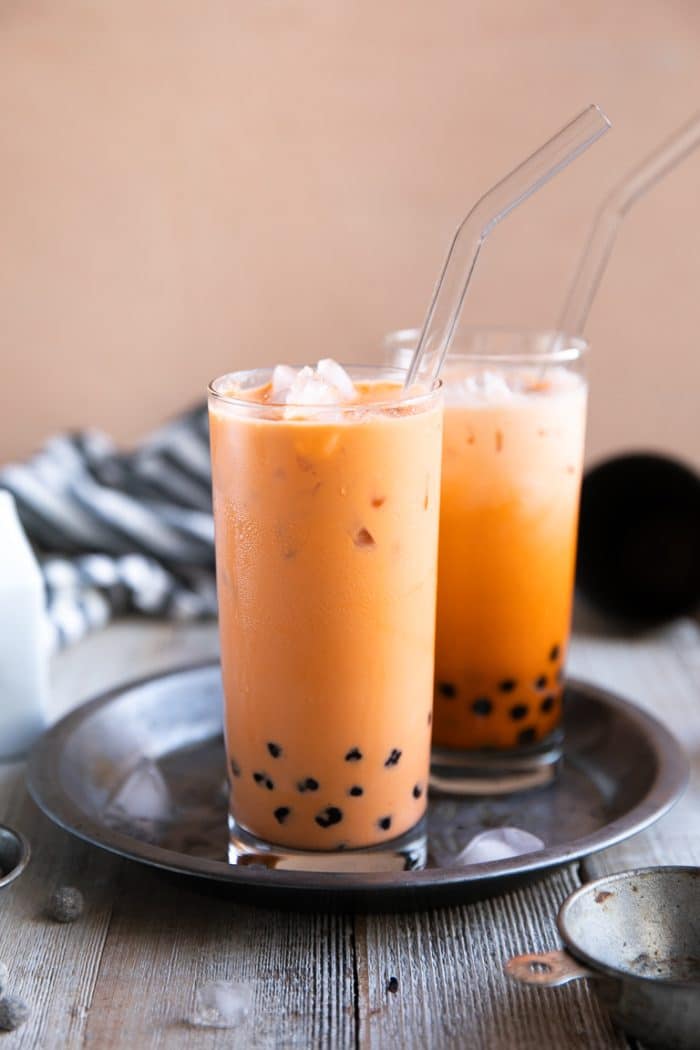 Two glasses filled with ice cold thai bubble tea.