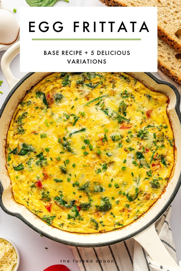 Vertical Pinterest pin image featuring a baked egg frittata in a cream-colored enameled cast iron braiser on a white marble surface. A large white text box overlay at the top reads “EGG FRITTATA” in bold black letters and “BASE RECIPE + 5 DELICIOUS VARIATIONS” in smaller black text below, separated by a thin green line. The frittata is golden yellow with melted cheese, visible broccoli, spinach, onions, and red bell pepper, and chopped chives scattered over the top. Seeded bread is visible in the upper right corner, a white kitchen towel with thin black stripes is under the pan, a small white bowl of shredded cheese is partially visible at the lower left, and “the forked spoon” appears in small black text near the bottom.