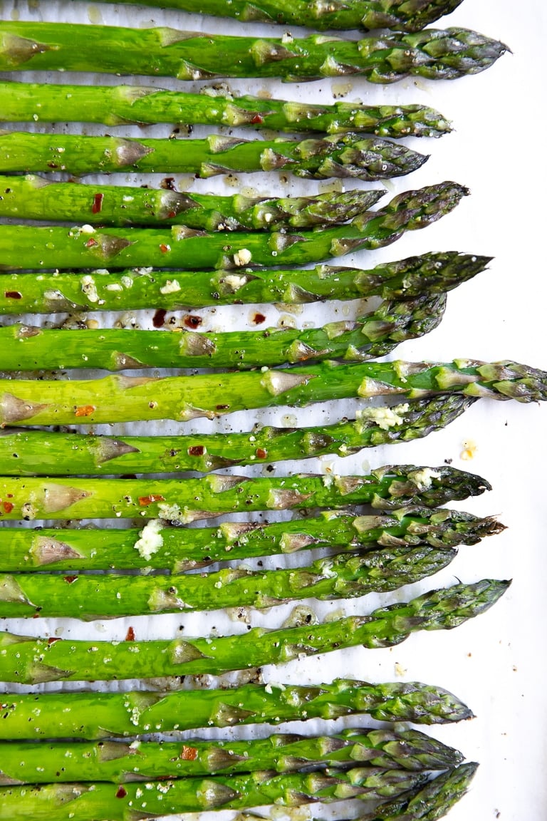Roasted asparagus seasoned with fresh garlic, salt, pepper, and crushed red pepper.