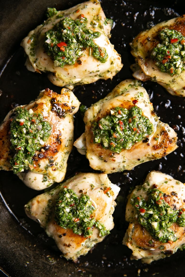 Chimichurri chicken thighs topped with homemade chimichurri sauce.