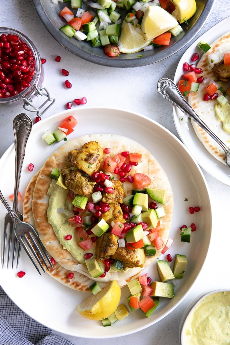 Overhead image of curried chicken gyros with curried yogurt sauce.