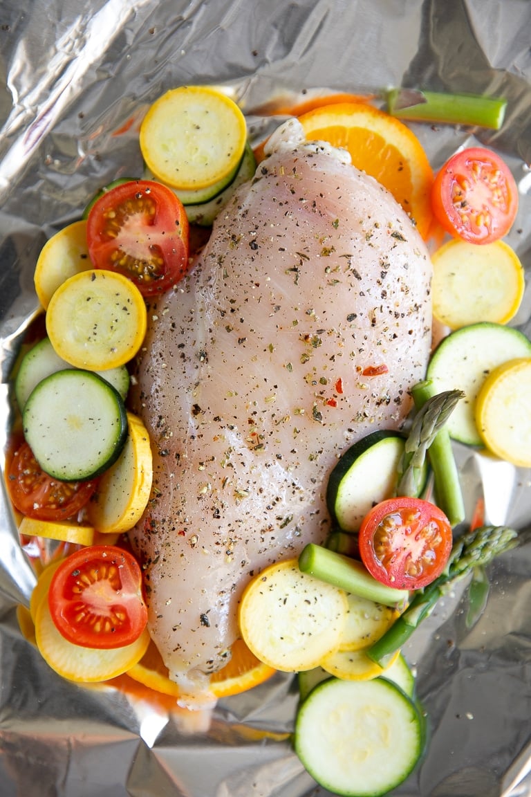 Single chicken breast and and chopped mixed vegetables in foil.