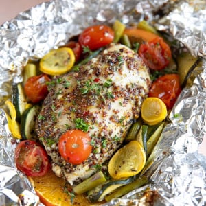 Honey Dijon Chicken Foil Packets with chopped vegetables.