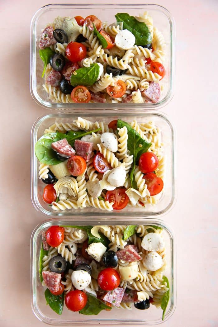 Three meal prep containers filled with leftover Italian Pasta Salad.
