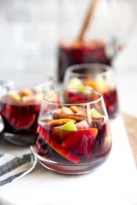 Three glasses and a pitcher of classic sangria.