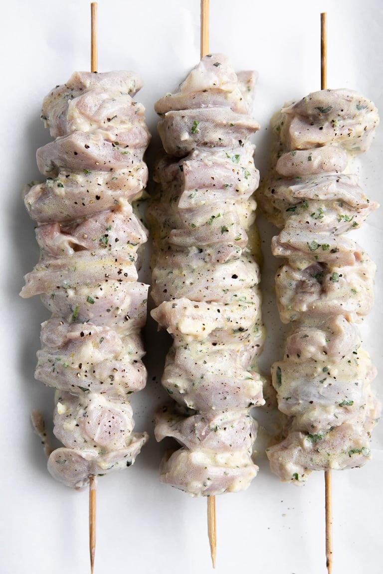 Three skewers threaded with yogurt marinated chicken.