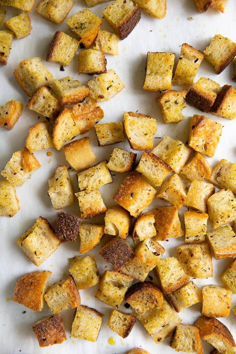 Perfectly toasted croutons on a large baking sheet.