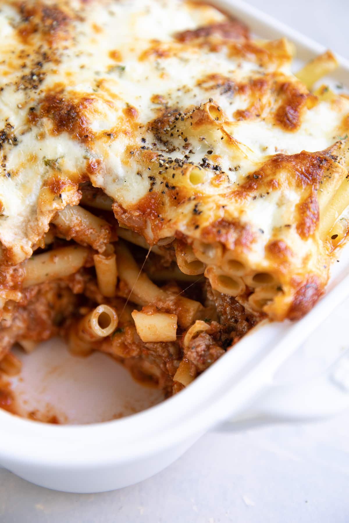 Casserole dish filled with cheesy baked ziti.