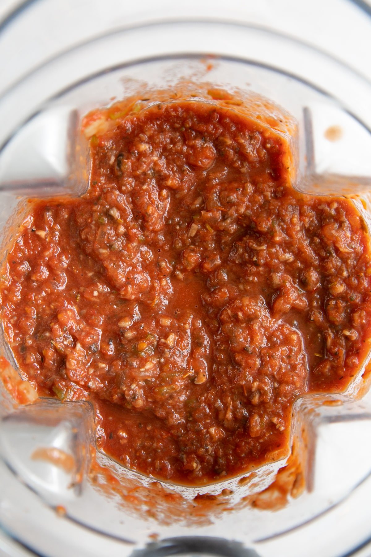 Blender filled with chunky processed tomato sauce.