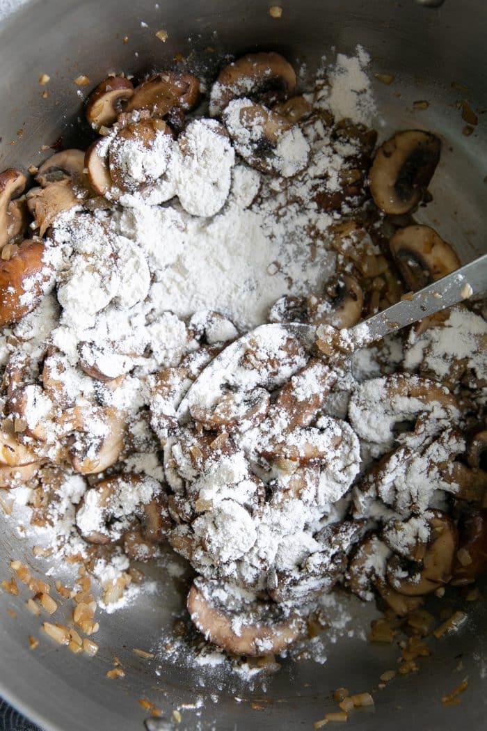 Onions and mushrooms in a large skillet sprinkled with flour.