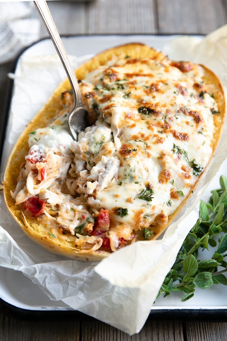 Half of one whole spaghetti squash baked and twice baked with chicken, cheeses, and tomatoes.