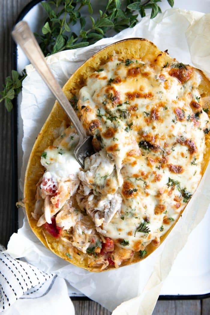 Overhead image of twice baked spaghetti squash filled chicken and cheeses.