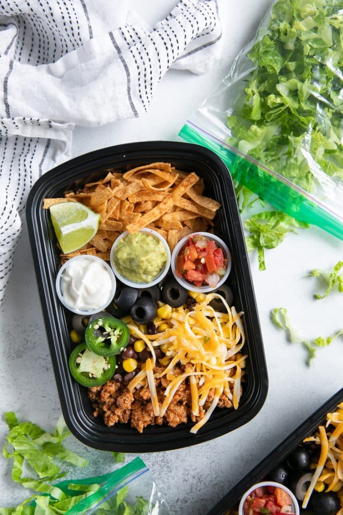 A tray of food on a table, with Taco Salad bowls