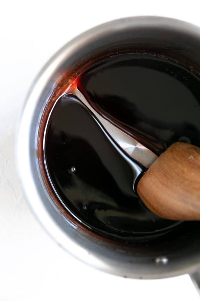 Medium saucepan filled with reduced syrupy pomegranate molasses.