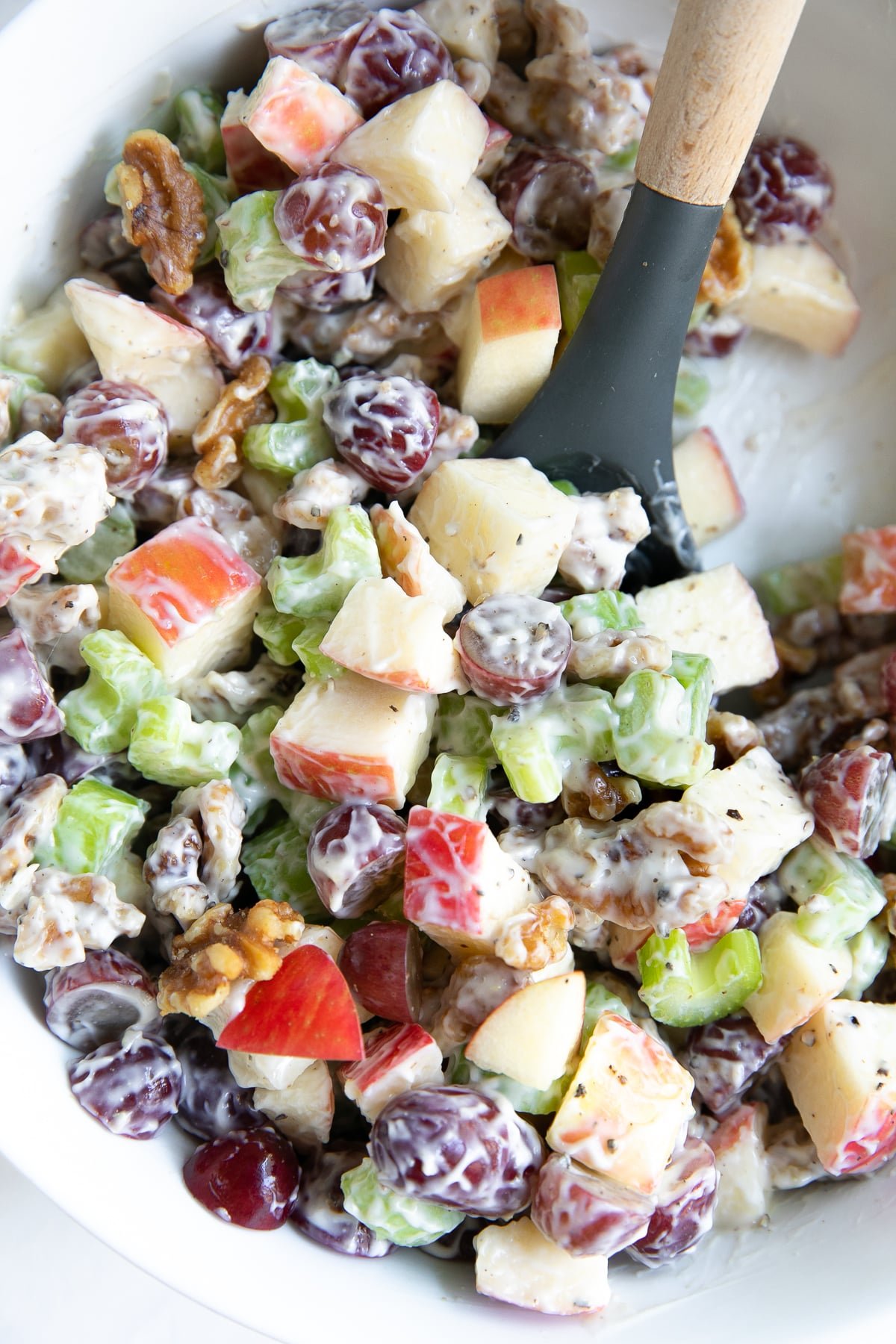 Salad made with diced apples, grapes, walnuts, and chopped celery, tossed in mayonnaise