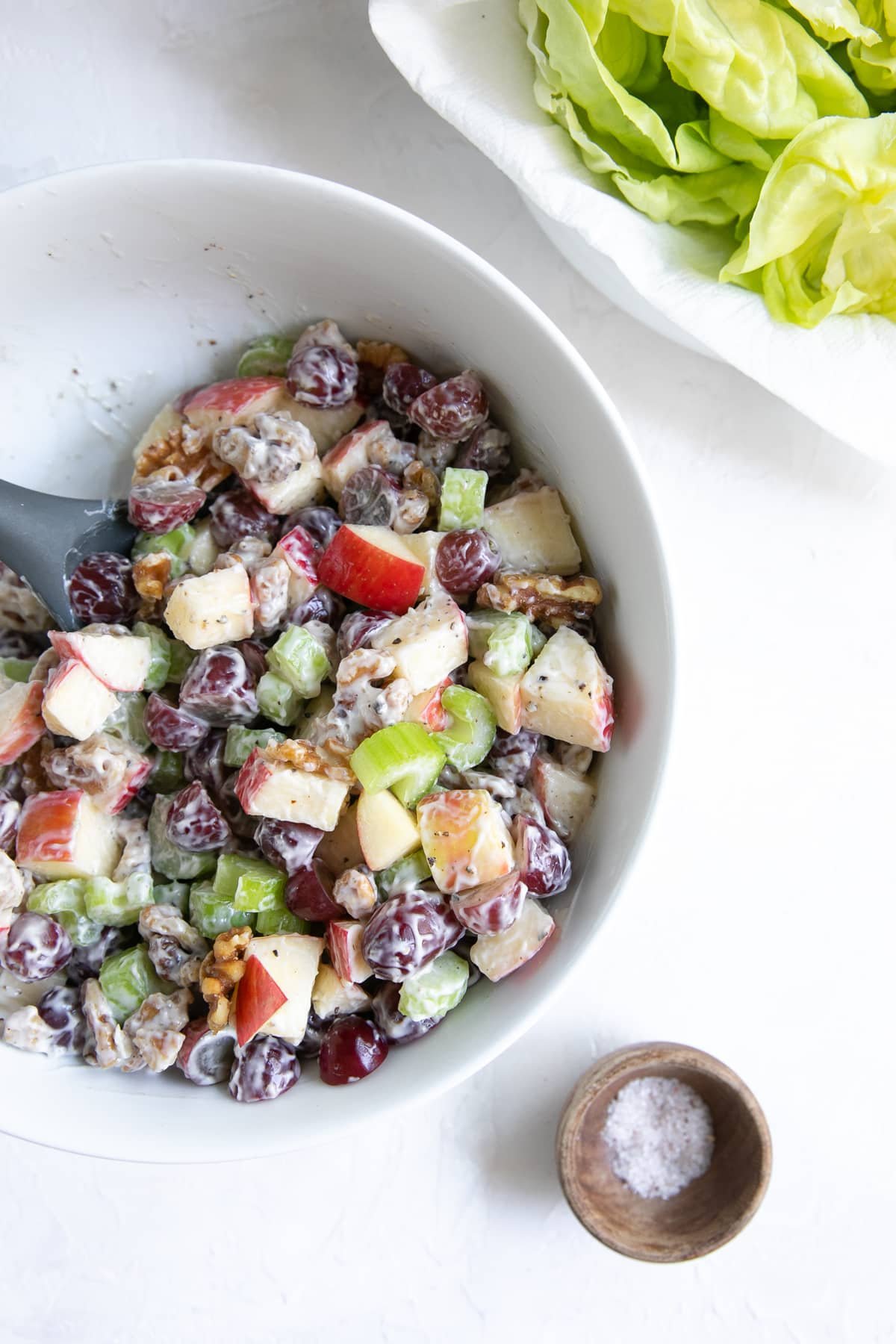 Salad made with diced apples, grapes, walnuts, and chopped celery, tossed in mayonnaise