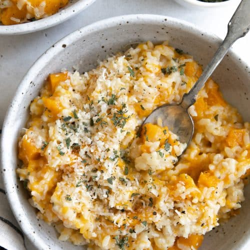 Shallow ceramic bowl filled with creamy butternut squash risotto.