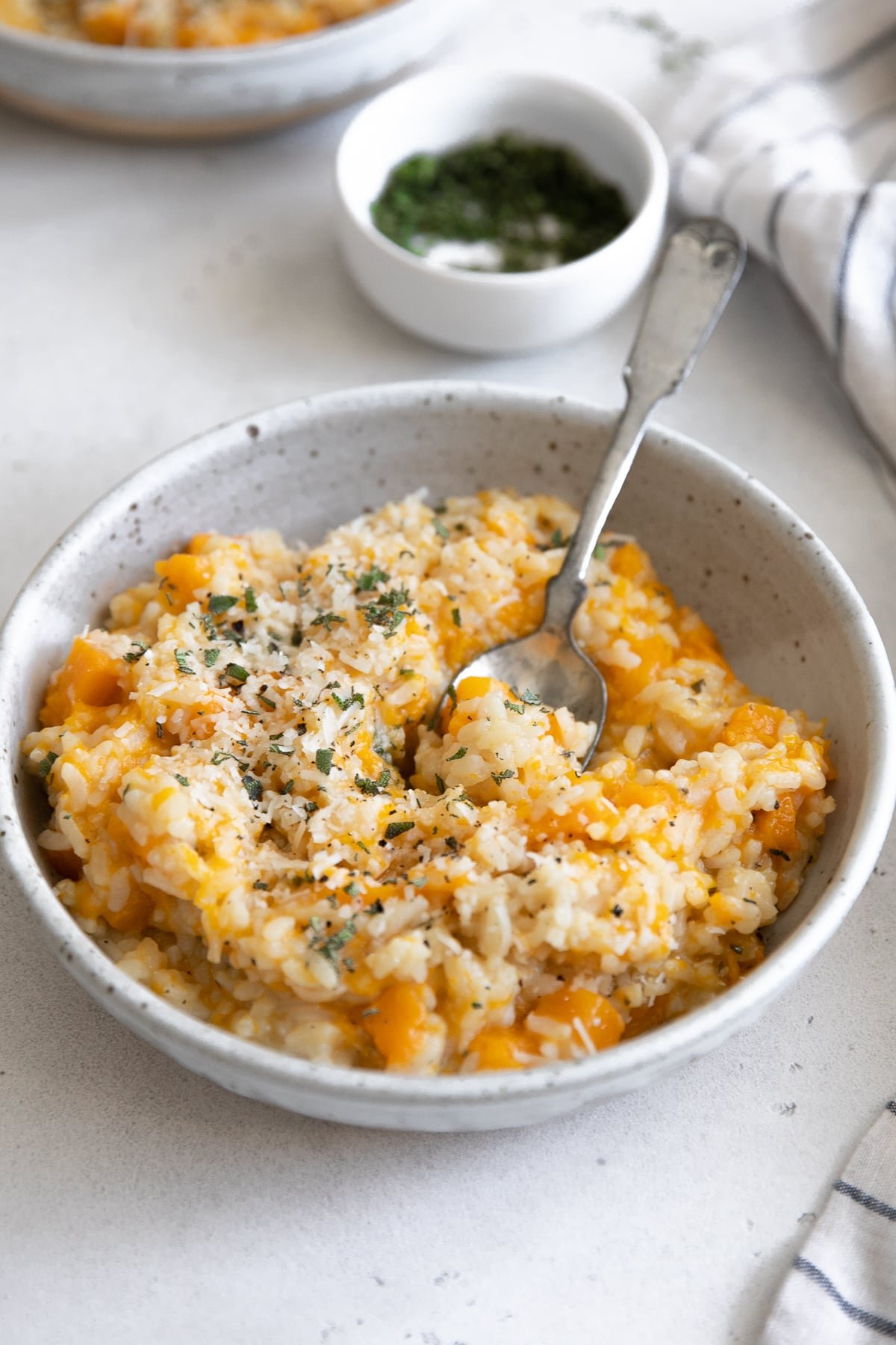 Shallow ceramic bowl filled with creamy butternut squash risotto.